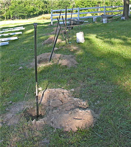 Fence post holes being enlarged