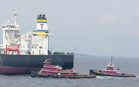 Tugs escorting a tanker ship into Casco Bay